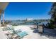 Charming outdoor patio featuring lounge chairs, BBQ grills, overlooking the water at 19937 Gulf Blvd # B-3, Indian Shores, FL 33785