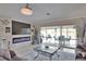 Relaxing living room with fireplace, ceiling fan, and sliding glass doors leading to the pool at 22516 Bolanos Ct, Port Charlotte, FL 33952