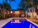 Stunning backyard pool and patio area with a dining area and egg chair at 238 31St N Ave, St Petersburg, FL 33704