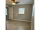 This bedroom offers a calming and neutral palette with a ceiling fan and a window for natural light at 2418 S Ramona Cir, Tampa, FL 33612