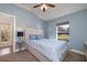 Comfortable bedroom with a queen bed, soft blue walls, and view of the outside acreage at 2659 Keystone Springs Rd, Tarpon Springs, FL 34688