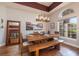 Elegant dining room with hardwood floors, large windows, and a rustic wooden table at 2659 Keystone Springs Rd, Tarpon Springs, FL 34688