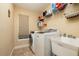 Bright laundry room featuring new washer and dryer and utility sink at 2659 Keystone Springs Rd, Tarpon Springs, FL 34688