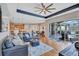 Open-concept living room featuring hardwood floors, a ceiling fan, and sliding glass doors to the pool at 2659 Keystone Springs Rd, Tarpon Springs, FL 34688