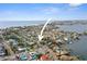 An aerial view highlights the location of the property within the community, nearby the bay and distant cityscapes at 266 44Th Ave, St Pete Beach, FL 33706