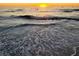 Serene beach sunset reflecting over gentle waves, epitomizing peaceful coastal living at 266 44Th Ave, St Pete Beach, FL 33706