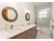 Elegant bathroom featuring dual sinks, marble countertops, and a glass-enclosed shower at 2660 Powell Ln, Tarpon Springs, FL 34688