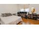 Calm bedroom offering warm hardwood floors, ample workspace, and natural light at 2660 Powell Ln, Tarpon Springs, FL 34688