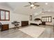 Spacious bedroom with wood floors, multiple ceiling fans, and natural light at 2660 Powell Ln, Tarpon Springs, FL 34688