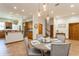 Open dining area adjacent to the kitchen, featuring a round table with gray chairs and modern lighting at 2660 Powell Ln, Tarpon Springs, FL 34688