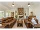 Comfortable living room features stone fireplace, two sofas, and bright natural light at 2660 Powell Ln, Tarpon Springs, FL 34688
