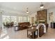 Spacious open-plan living area featuring stone fireplace, bright natural light, and dining space at 2660 Powell Ln, Tarpon Springs, FL 34688