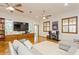 Spacious living room with hardwood floors, modern media center, and comfortable seating at 2660 Powell Ln, Tarpon Springs, FL 34688