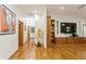 Bright living room with hardwood floors, built-in shelving, and hallway access at 2660 Powell Ln, Tarpon Springs, FL 34688