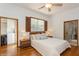 Bright bedroom with hardwood floors and en-suite bath access at 2660 Powell Ln, Tarpon Springs, FL 34688