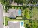 A captivating aerial view of a house with a screened-in pool and a well-maintained, expansive backyard at 2911 Silva Wood Dr, Valrico, FL 33596