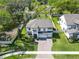 Stunning aerial view of a two-story home with a spacious yard, complemented by mature trees at 2911 Silva Wood Dr, Valrico, FL 33596