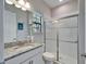 Bright bathroom featuring a granite vanity top and walk-in shower with glass doors at 2911 Silva Wood Dr, Valrico, FL 33596