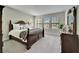 Spacious bedroom with large windows, a well-made bed, and plenty of natural light at 2911 Silva Wood Dr, Valrico, FL 33596