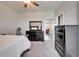 View of primary bedroom, featuring dark wood furniture and ceiling fan, overlooking the living room at 2911 Silva Wood Dr, Valrico, FL 33596