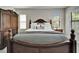 Cozy bedroom showcasing the bed, bedside table, and a large wardrobe at 2911 Silva Wood Dr, Valrico, FL 33596