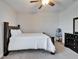 This bedroom offers a neutral color palette, a ceiling fan, and nice furnishings at 2911 Silva Wood Dr, Valrico, FL 33596