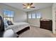Bright bedroom featuring three windows, neutral decor, and ample natural light at 2911 Silva Wood Dr, Valrico, FL 33596