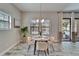 Cozy dining area adjacent to sliding glass doors with views of the refreshing pool at 2911 Silva Wood Dr, Valrico, FL 33596
