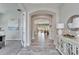 Inviting foyer with wood-look tile flooring, an arched entryway, and neutral wall colors at 2911 Silva Wood Dr, Valrico, FL 33596