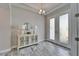 Bright foyer features tiled floors, a decorative mirror, and a glass-paneled front door at 2911 Silva Wood Dr, Valrico, FL 33596