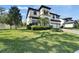 Beautiful two-story home with a manicured lawn, mature trees, and an inviting front entrance at 2911 Silva Wood Dr, Valrico, FL 33596