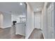 Hallway with wood floors, leading to an open living area with recessed lighting at 2911 Silva Wood Dr, Valrico, FL 33596