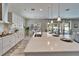 Gourmet kitchen has island with a sink, stainless appliances, and sliding doors to backyard oasis at 2911 Silva Wood Dr, Valrico, FL 33596