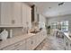 Bright kitchen features white cabinets, stainless steel appliances, and an eat-in dining area at 2911 Silva Wood Dr, Valrico, FL 33596