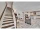 Open-concept living area with stairs, tile flooring, and modern decor with ample lighting at 2911 Silva Wood Dr, Valrico, FL 33596
