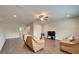 Spacious living area with wood floors, a ceiling fan, and a cozy seating arrangement at 2911 Silva Wood Dr, Valrico, FL 33596