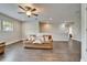Inviting living room featuring wood-look floors, a ceiling fan, and comfortable seating at 2911 Silva Wood Dr, Valrico, FL 33596