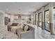 Spacious living area with kitchen view, modern lighting, and sliding glass doors to outdoor pool at 2911 Silva Wood Dr, Valrico, FL 33596