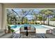 Outdoor patio overlooking screened-in pool and landscaped backyard at 2911 Silva Wood Dr, Valrico, FL 33596