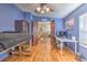 Bright bedroom featuring hardwood floors and a lofted bed adjacent to an office space at 3025 Hickory Dr, Wesley Chapel, FL 33543