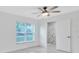 Bright bedroom featuring tile floors, ceiling fan, and ensuite bath at 3184 Cypress Green Dr, Palm Harbor, FL 34684