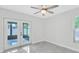 A bedroom features French doors to an outdoor patio and tile flooring at 3184 Cypress Green Dr, Palm Harbor, FL 34684