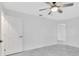 Bright bedroom features a ceiling fan and gray tile flooring at 3184 Cypress Green Dr, Palm Harbor, FL 34684