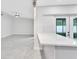 Open concept kitchen island with quartz countertops and view of the adjacent living area at 3184 Cypress Green Dr, Palm Harbor, FL 34684