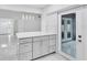 Open concept kitchen with quartz countertops, stainless appliances, and stylish grey cabinetry at 3184 Cypress Green Dr, Palm Harbor, FL 34684