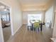 Dining room with wood floors, bench, chairs, table, and sliding glass doors leading to a pool at 3212 Kilmer Dr, Plant City, FL 33566