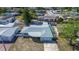 An aerial view showcases this lovely single story home with screened in patio and concrete driveway, surrounded by a fenced yard at 3438 Bigelow Dr, Holiday, FL 34691