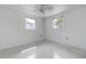 Simple bedroom featuring updated ceiling fan and bright windows at 3438 Bigelow Dr, Holiday, FL 34691