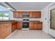 Functional kitchen showcasing oak cabinetry, stainless steel appliances, and granite countertops for stylish and efficient cooking at 3438 Bigelow Dr, Holiday, FL 34691