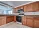 Modern kitchen featuring oak cabinets, granite counters, and stainless-steel appliances at 3438 Bigelow Dr, Holiday, FL 34691